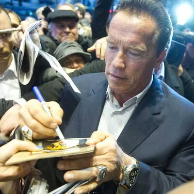 Arnie gibt Fans Autogramme