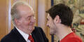 Iker Casillas (R) is congratulated by the Juan Carlos