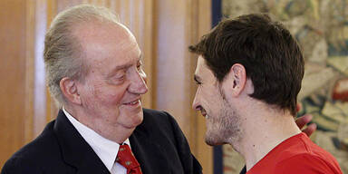 Iker Casillas (R) is congratulated by the Juan Carlos