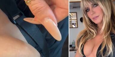 Heidi Klum zupft sich ein langes graues Haar aus.&nbsp;