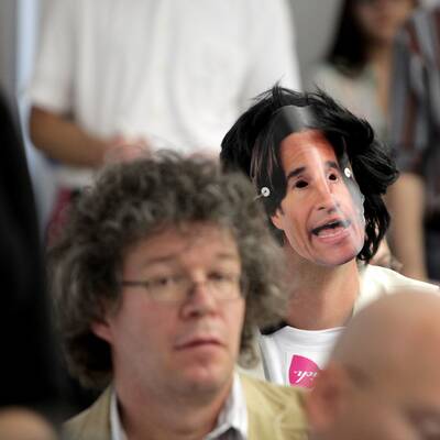 Maskenträger bei KHG-Pressekonferenz