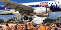 Flieger landet neben Strandgästen