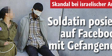 Soldatin posiert mit Gefangenen